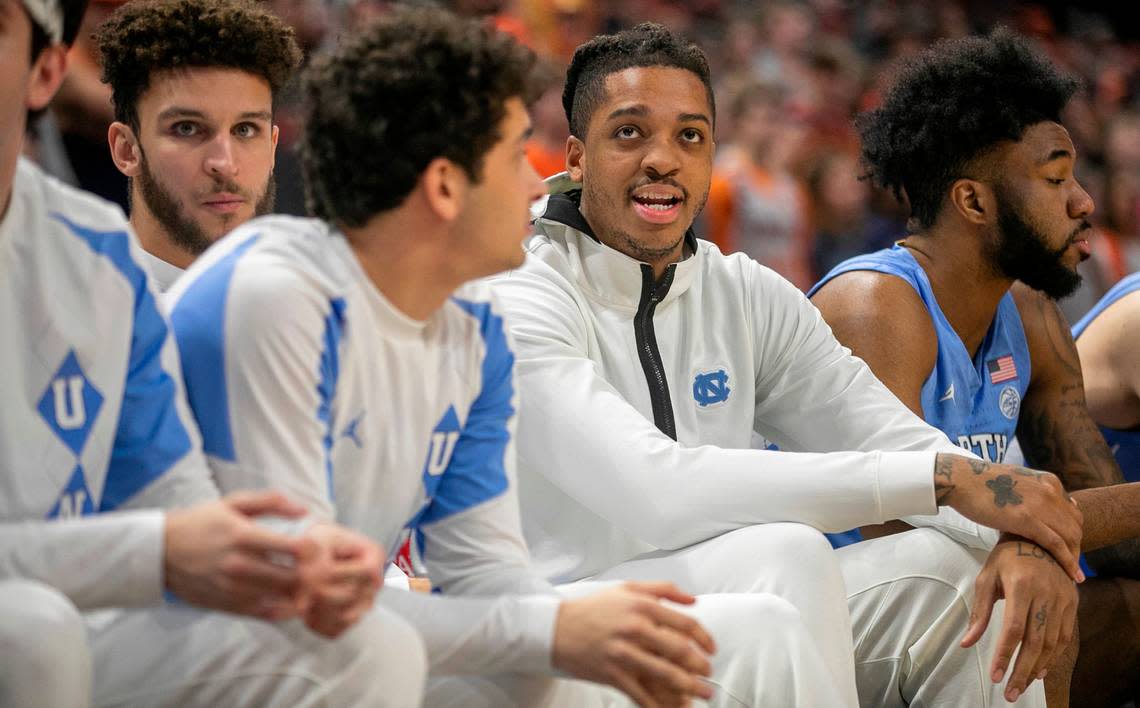 North Carolina’s Armando Bacot (5) watches the second half against Virginia from the bench after injuring his left foot in the opening minute of play on Tuesday, January 10, 2023 at John Paul Jones Arena in Charlottesville, Va.