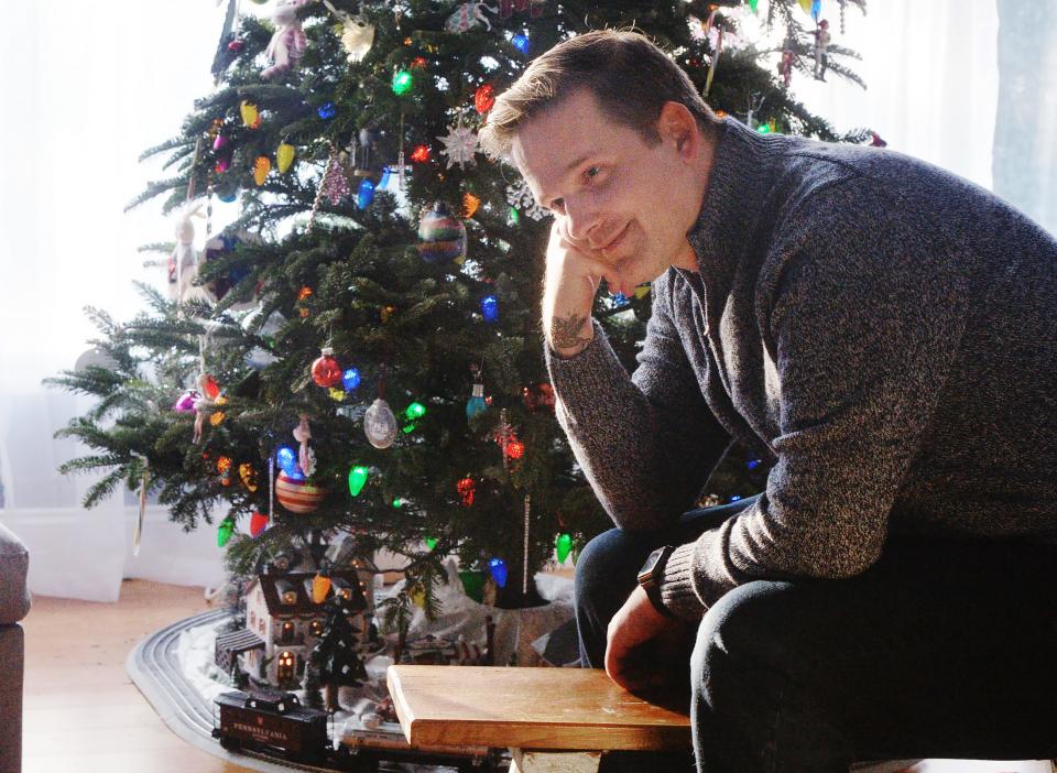 Erie resident Jay Breneman, 40, watches his children play at home on Dec. 29.