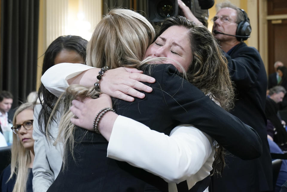 Sandra Garza, the long-time partner of fallen Capitol Police Officer Brian Sicknick, right, hugs U.S. Capitol Police officer Caroline Edwards as they leave after the House select committee investigating the Jan. 6 attack on the U.S. Capitol held its first public hearing to reveal the findings of a year-long investigation, on Capitol Hill in Washington, Thursday, June 9, 2022. (AP Photo/Andrew Harnik)