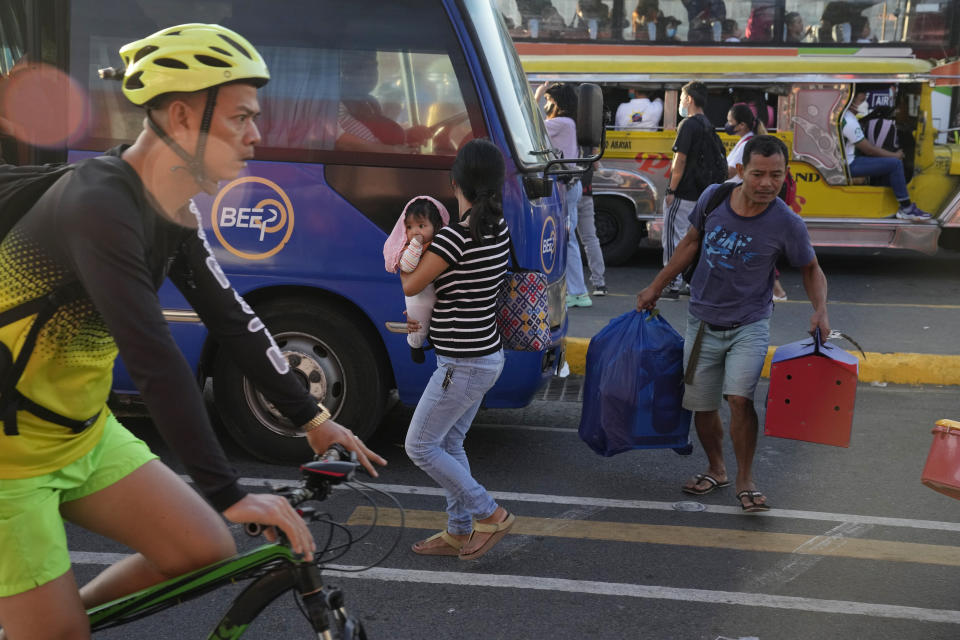 Commuters wait for a ride during a transport strike in Quezon city, Philippines on Monday, March 6, 2023. Philippine transport groups launched a nationwide strike Monday to protest a government program drivers fear would phase out traditional jeepneys, which have become a cultural icon, and other aging public transport vehicles. (AP Photo/Aaron Favila)