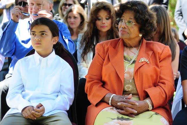 <p>ROBYN BECK/AFP via Getty</p> Michael Jackson's mother Katherine Jackson and son Blgi attend a ceremony honoring late singer at the Children's Hospital in Los Angeles in August 2011.