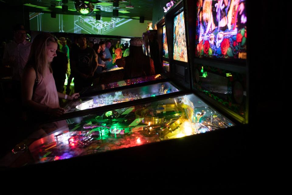 A woman is focused on her game at Stardust Pinbar on Aug. 8, 2019, in Phoenix.
