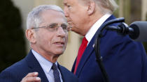 Dr. Anthony Fauci, director of the National Institute of Allergy and Infectious Diseases, takes the podium to speaks about the coronavirus in the Rose Garden of the White House, Monday, March 30, 2020, in Washington, as President Donald Trump listens. (AP Photo/Alex Brandon)
