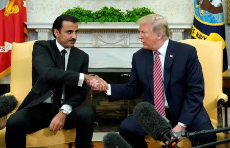 U.S. President Donald Trump meets Qatar's Emir Sheikh Tamim bin Hamad al-Thani in the Oval Office at the White House in Washington, DC, U.S., April 10, 2018. REUTERS/Kevin Lamarque/Files