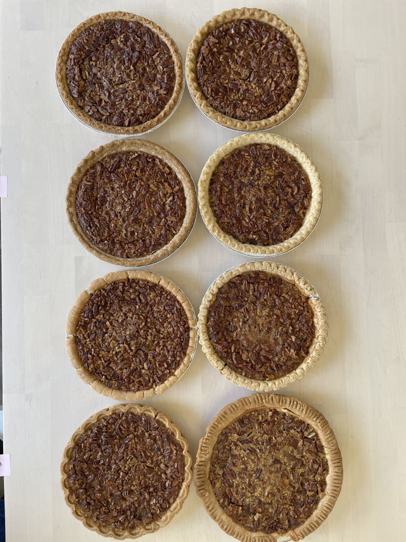 8 pecan pies on table with different thickness and colring on crust