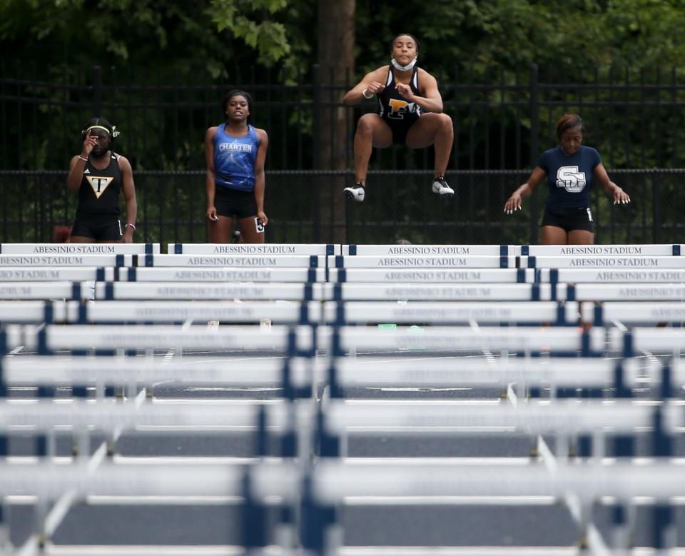 Padua's Jia Anderson pops in the air in preparation for the 100 meter hurdles before winning the event during the New Castle County track and field championships Saturday, May 15, 2021 at Abessinio Stadium.