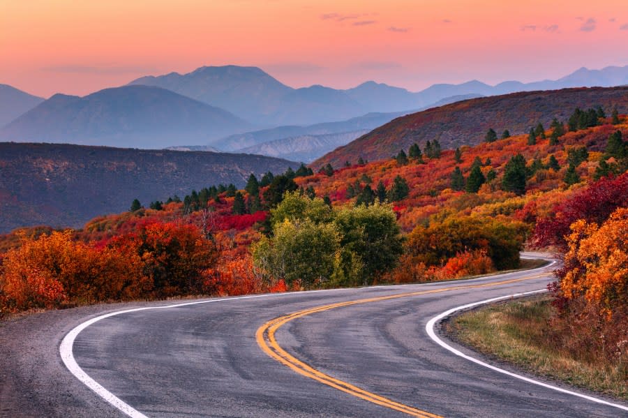 Winding mountain road and autumn landscape with vibrant fall colors near Gunnison, Colorado. (Getty Images)