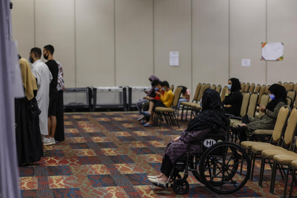 Afghan nationals wait for results of the Covid-19 tests after arriving to the National Conference Center (NCC), which in recent months has been redesigned to temporarily house Afghan nationals on August 11, 2022 in Leesburg, Virginia.  / Credit: Getty Images