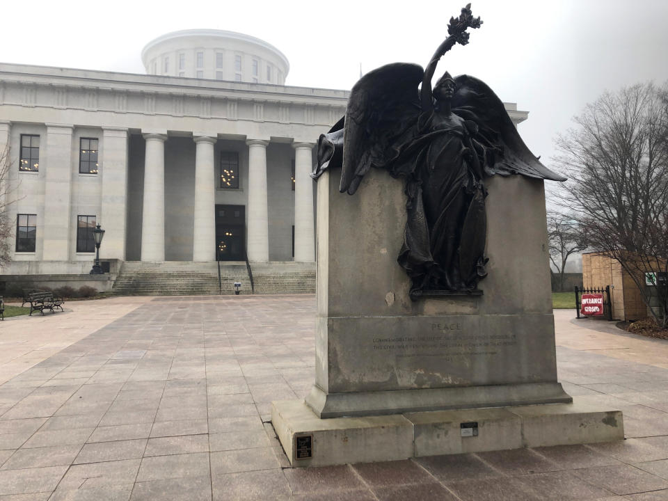 "Peace," a statue on the grounds of the Ohio Statehouse that commemorates Civil War soldiers "And The Loyal Women Of That Period," stands clear of morning fog on Wednesday, Jan. 15, 2020, in Columbus, Ohio. The Statehouse grounds don't include a statue of a real woman from Ohio history, an occurrence the Women's Suffrage Centennial Commission hopes to remedy by proposing a new memorial honoring the women who fought for the right to vote. (AP Photo/Andrew Welsh-Huggins)
