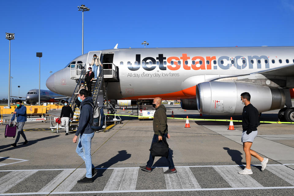 Passengers disembark Jetstar flight JQ505 from Sydney upon arriving at Tullamarine Airport in Melbourne on November 1, 2021.