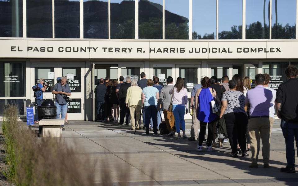 A long line of people wait to clear security to enter the El Paso County Terry R. Harris Judicial Complex, Monday, June 26, 2023, in Colorado Springs, Colo. A hearing is being held for the suspect in the Club Q mass shooting. The suspect is expected to plead guilty in the attack that left five people dead and wounded 17 just before Thanksgiving Day 2022 at the longtime sanctuary for the LGBTQ+ community in this mostly conservative city. (AP Photo/David Zalubowski)