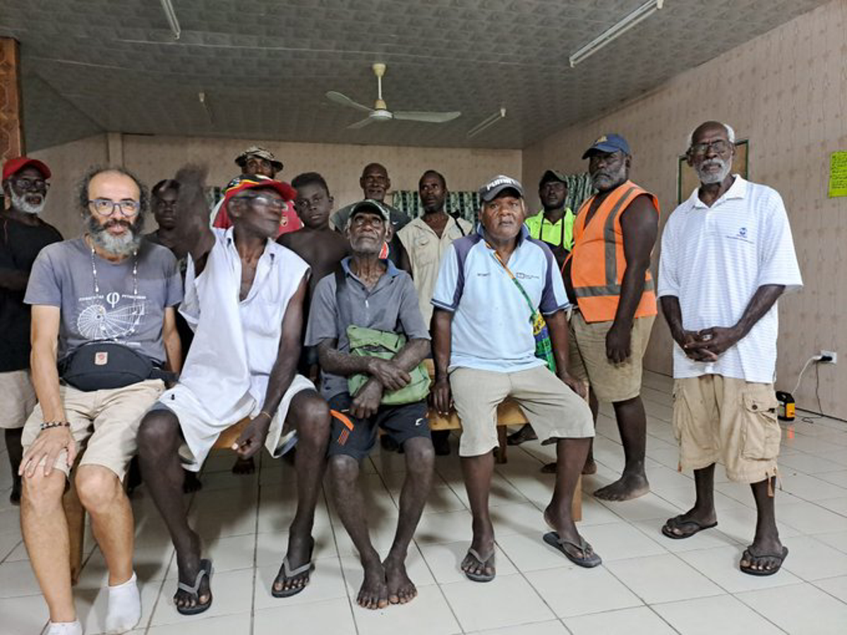 Gianluca Grimalda with residents in Papua New Guinea. He says his promise to locals about cutting his carbon footprint has given him resolve (Gianluca Grimalda)