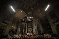 Faithful and prelates gather in front of the altar during the Christmas Eve Mass celebrated by Pope Francis in St. Peter's Basilica at the Vatican, Monday, Dec. 24, 2018. (AP Photo/Alessandra Tarantino)