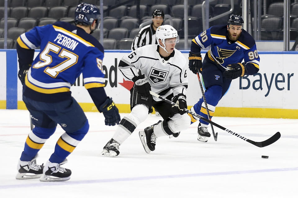 Los Angeles Kings' Olli Maatta (6) controls the puck while under pressure from St. Louis Blues' Ryan O'Reilly (90) and David Perron (57) during the first period of an NHL hockey game Wednesday Feb. 24, 2021, in St. Louis. (AP Photo/Scott Kane)