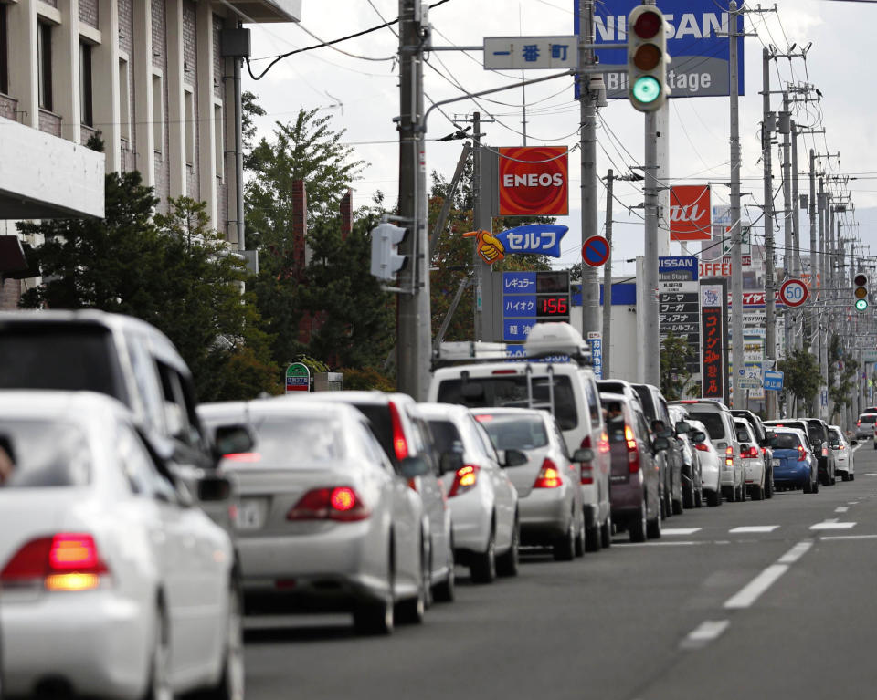 Cars are queued up as drivers wait to buy gas after an earthquake in Ebetsu, Hokkaido, northern Japan, Thursday, Sept. 6, 2018. A powerful earthquake rocked Japan’s northernmost main island of Hokkaido early Thursday, triggering landslides that crushed homes, knocking out power across the island, and forcing a nuclear power plant to switch to a backup generator. (Kyodo News via AP)