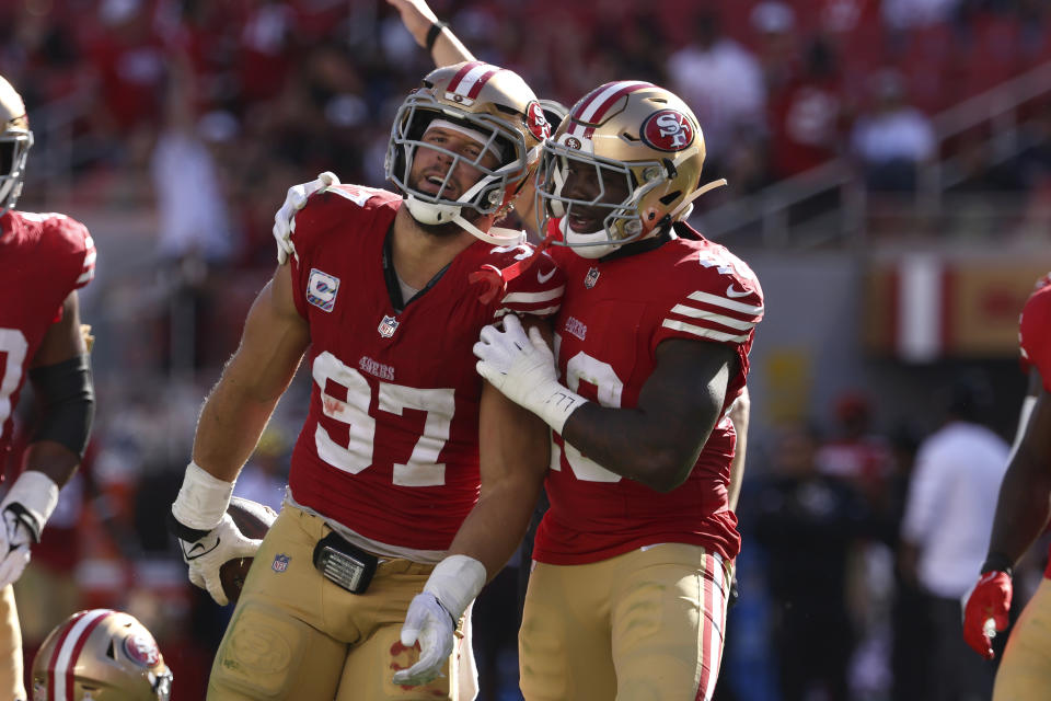 San Francisco 49ers defensive end Nick Bosa, left, is congratulated by linebacker Tatum Bethune (48) after Bosa sacked and recovered a fumble by New England Patriots quarterback Jacoby Brissett during the second half of an NFL football game in Santa Clara, Calif., Sunday, Sept. 29, 2024. (AP Photo/Jed Jacobsohn)