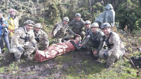 Rescue members pose for a picture with Spanish speleologist Cecilio Lopez-Tercero (C) after he was rescued from a cave where he was trapped for 12 days, in Leymebamba, Chachapoyas, in this handout photograph distributed to the media on September 30, 2014. REUTERS/Peruvian Air Force/Handout via Reuters
