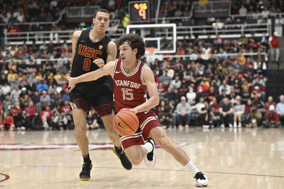 Stanford guard Benny Gealer (15) drives past Southern California guard Kobe Johnson (0) during the second half of an NCAA college basketball game Saturday, Feb. 10, 2024, in Stanford, Calif. (AP Photo/Nic Coury)