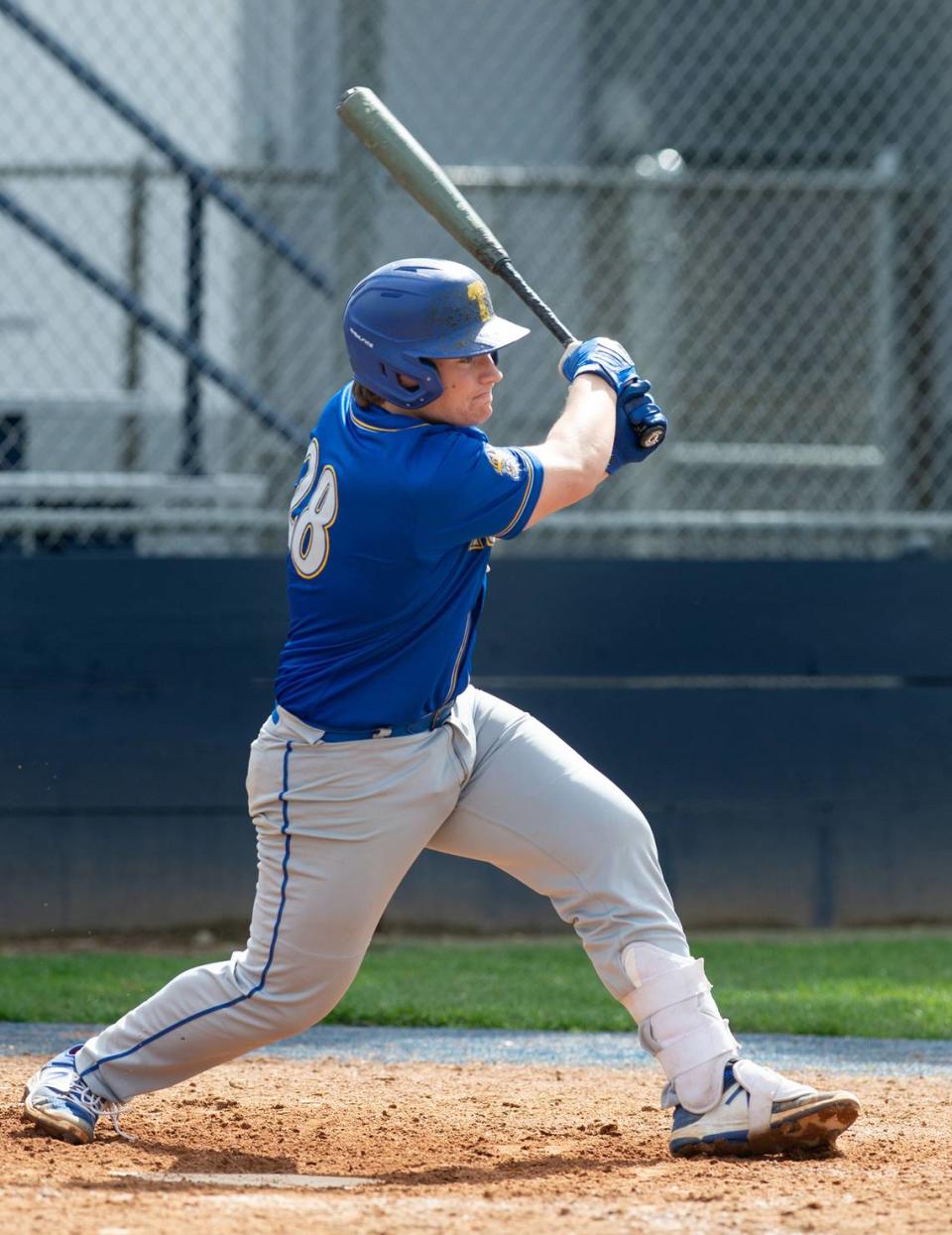 Turlock’s Jorge Orozco hits a two-run double during the Central California Athletic league game at Downey High School in Modesto, Calif., Thursday, March 23, 2023. Turlock won the game 5-2.