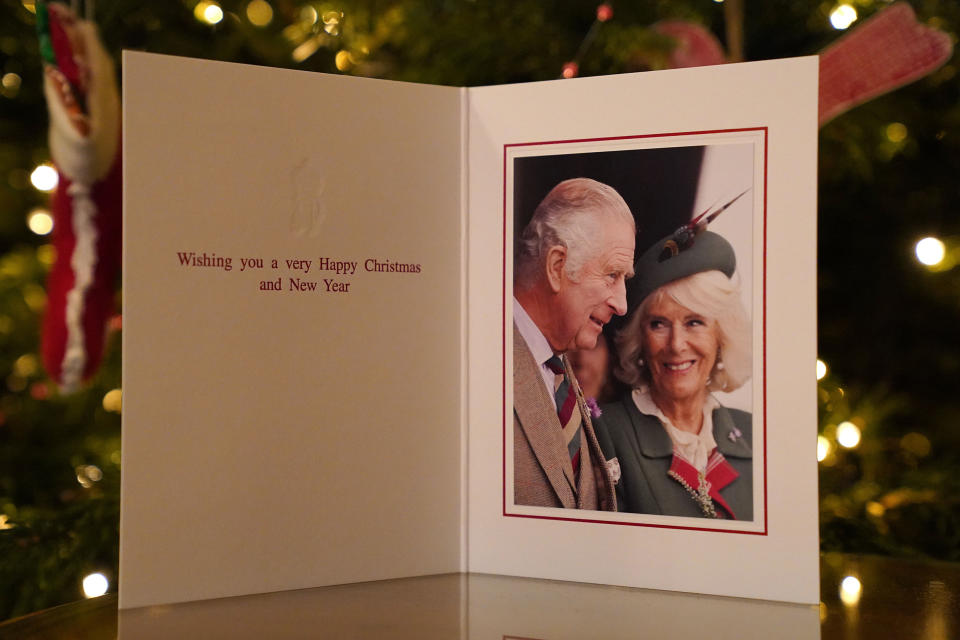 The 2022 Christmas card of King Charles III and the Queen Consort in front of a Christmas tree in Clarence House, London. (Sam Hussein / PA)