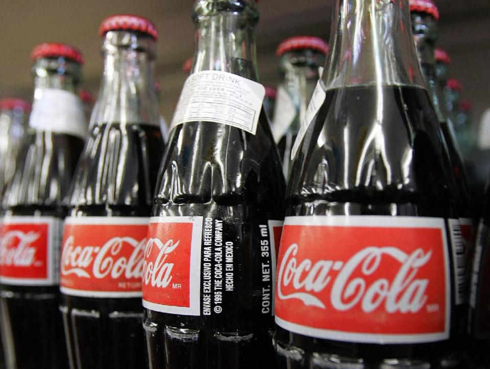 FILE - In this Nov. 3, 2004 file photo, bottles of Mexican Coca-Cola fill a prominent spot on the shelves of the Tarascas Latino Supermarket in Lawrenceville, Ga. Americans who buy the glass bottles of Coke exported from Mexico may have been dismayed by recent online reports that an independent bottler that supplies the drinks planned to switch from sugar to fructose to cut costs. But Arca Continental, the Mexican bottler in question, stressed in a statement that it has no plans to change the sweetener for the "Coca-Cola Nostalgia" bottles it exports to the U.S. (AP Photo/Ric Feld, File)