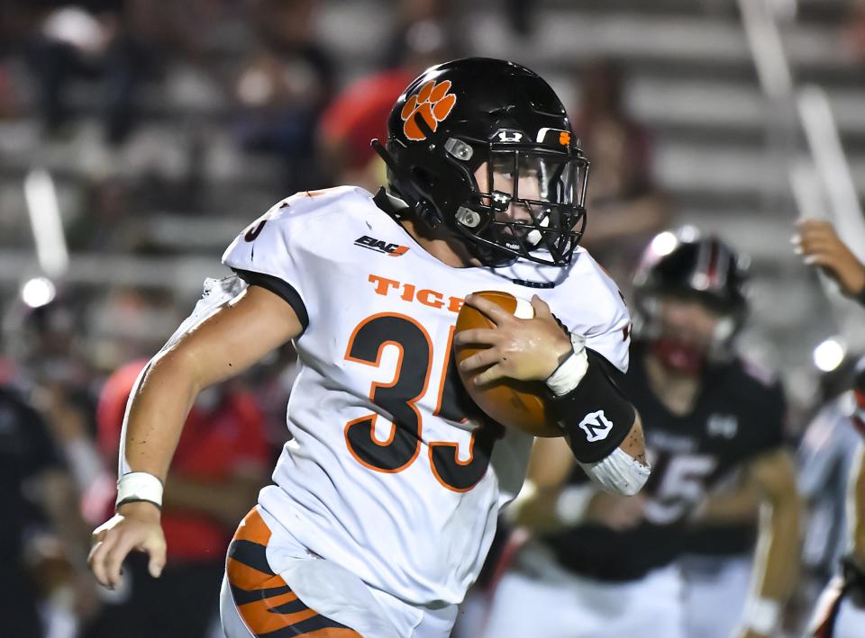 Niko Ferreira of Lawrenceburg runs the ball against East Central during the Skyline Chili Crosstown Showdown at East Central High School on Friday, Aug. 19, 2022.