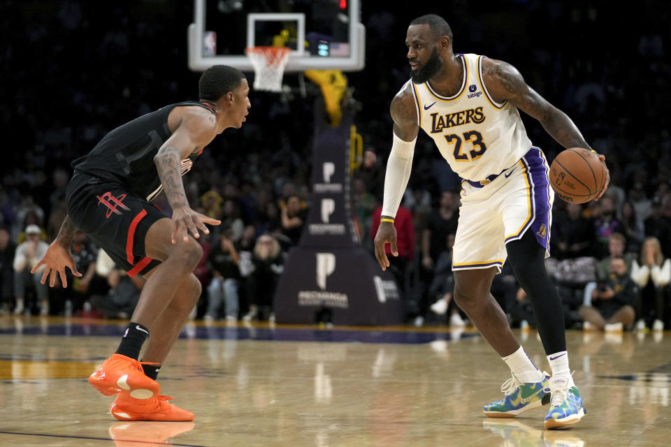 Los Angeles Lakers forward LeBron James (23) drives against Houston Rockets forward Jabari Smith Jr. (10) during the first half of an NBA basketball game in Los Angeles, Sunday, Nov. 19, 2023. (AP Photo/Eric Thayer)