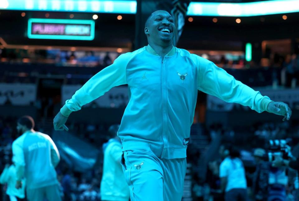 Charlotte Hornets forward Grant Williams is bathed in teal lighting as he runs across the court to bump a teammate prior to the team’s game against the Dallas Mavericks at Spectrum Center in Charlotte, NC on Tuesday, April 9, 2024. The Mavericks defeated the Hornets 130-104.