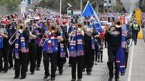 A marching band makes its way through the streets of Melbourne during the grand final parade. Pic: Getty