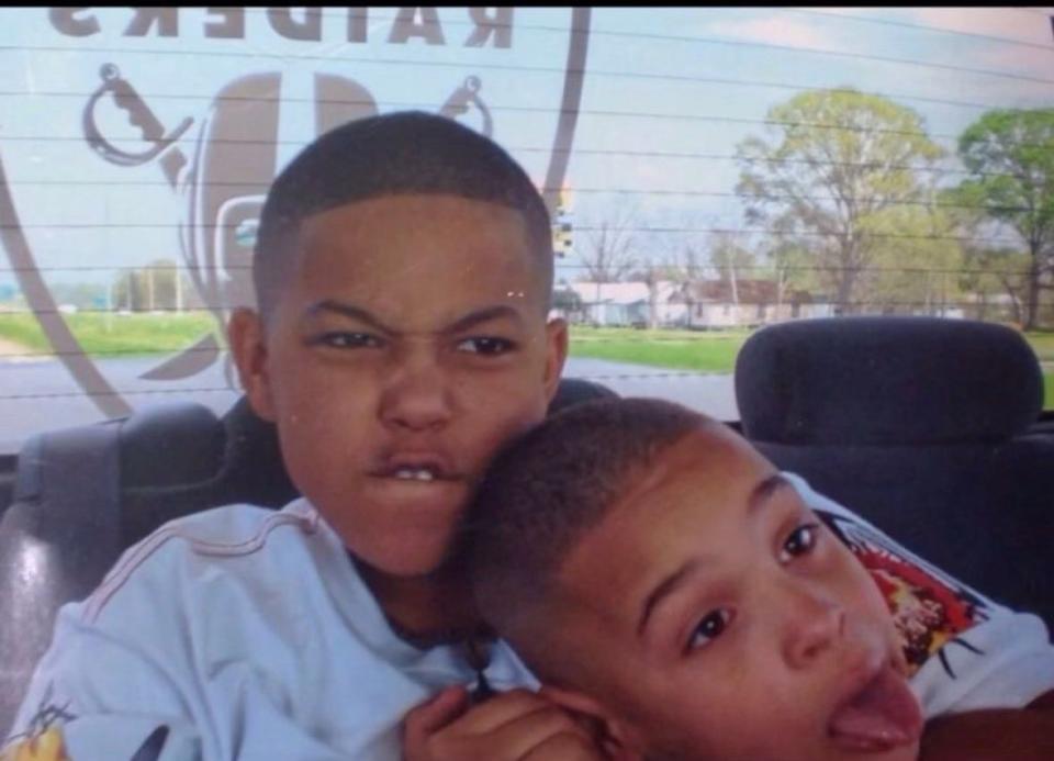 A 10-year-old Eddie Zinn-Turner, right, plays with his 6-year-old brother Charles Turner III in the backseat of a car when they were living in Louisiana for a time as children.