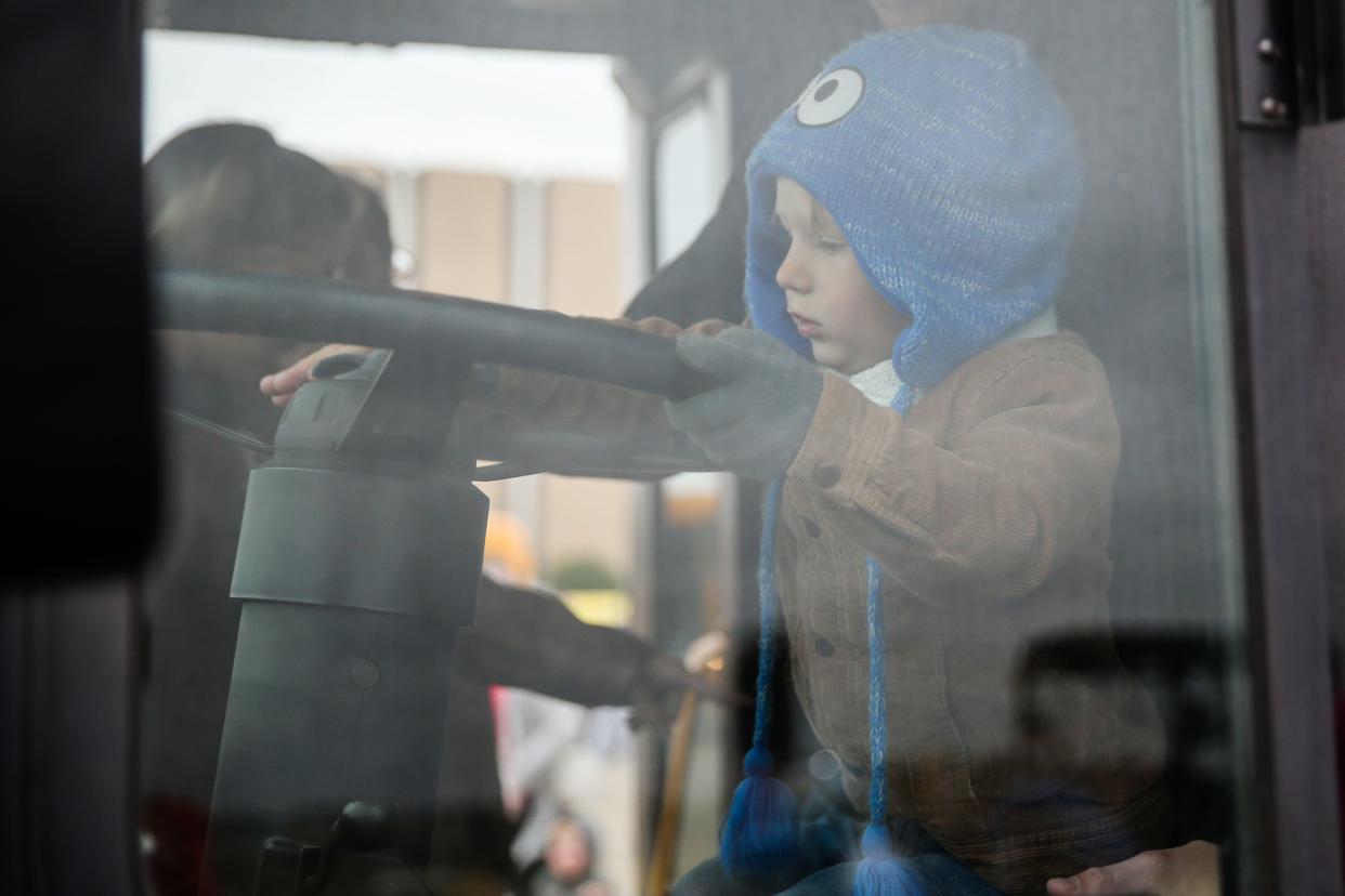 Colby Reding, 3, plays with the horn of a bus during Touch-a-Truck event Saturday, April 13, 2019, at San Angelo Stadium. 