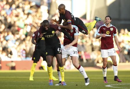 Football Soccer Britain - Burnley v Manchester City - Premier League - Turf Moor - 26/11/16 Manchester City's Yaya Toure and Fernandinho in action with Burnley's James Tarkowski Reuters / Andrew Yates Livepic