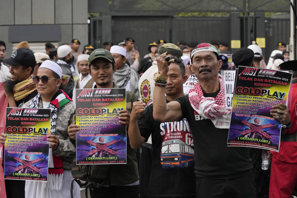 Muslims shout slogans during a rally against British band Coldplay outside the British embassy in Jakarta, Indonesia, Friday, Nov. 10, 2023. Dozens of conservative Muslims marched in Indonesia's capital on Friday calling for cancellation of Coldplay's concert later this month, saying the British band's support of lesbian, gay, bisexual, and transgender will corrupt young people. (AP Photo/Achmad Ibrahim)