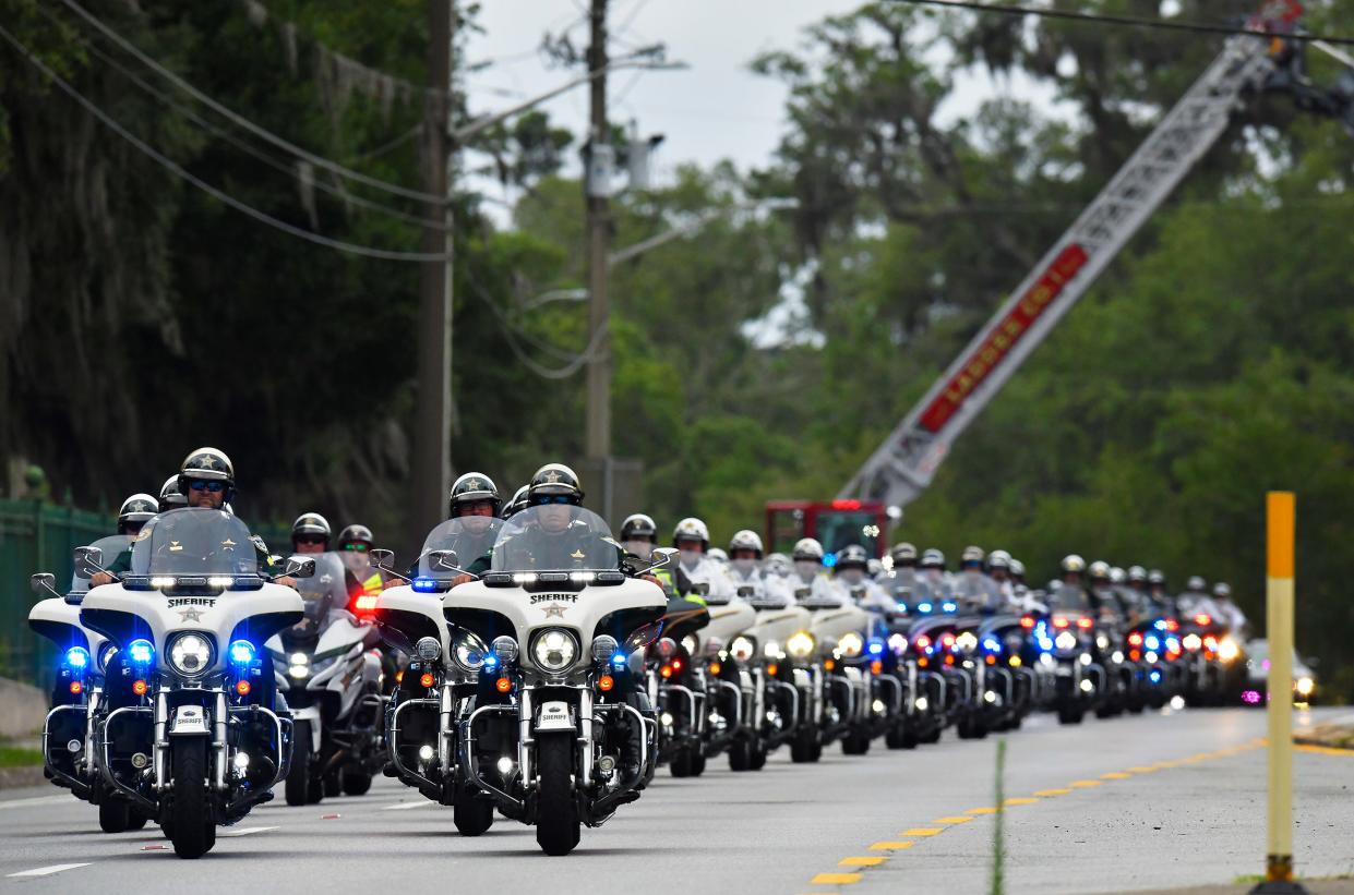 A line of motorcycle units from across the state lead the motorcade escorting the body of St. Johns County Sheriff's Office Sgt. Michael Kunovich arrives at Oaklawn Cemetery on May 26. The 52-year-old experienced medical distress and died after an altercation during an arrest.