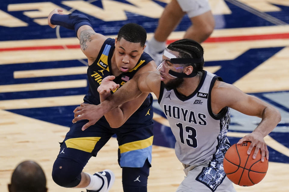 Georgetown's Donald Carey, right, drives past Marquette's Greg Elliott during the second half of an NCAA college basketball game in the Big East conference tournament Wednesday, March 10, 2021, in New York. (AP Photo/Frank Franklin II)