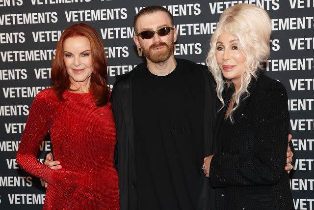 <p>Vittorio Zunino Celotto/Getty</p> Marcia Cross poses with Vetements creative director Guram Gvasalia and Cher backstage at Paris Fashion Week