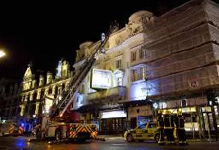 Emergency services look at the roof of the Apollo Theatre on Shaftesbury Avenue after part of the ceiling collapsed in central London December 19, 2013.REUTERS/Neil Hall
