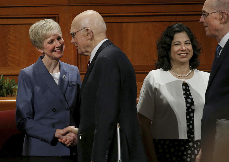 Sister Jean Bingham, left, Relief Society General President, greets President Dallin H. Oaks, First Counselor in the First Presidency, speaks during the general women's session of the 188th Semiannual General Conference of The Church of Jesus Christ of Latter-day Saints in the Conference Center in downtown Salt Lake City on Saturday, Oct. 6, 2018. At right is Sister Rayna Alburto, Second Counselor of the Relief Society General Presidency and President Henry B. Eyring, Second Counselor in the First Presidency. (Laura Seitz/The Deseret News via AP)