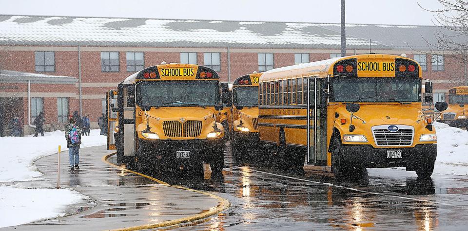 Students board the buses at the end of the school day in front of the Black River Education Center.