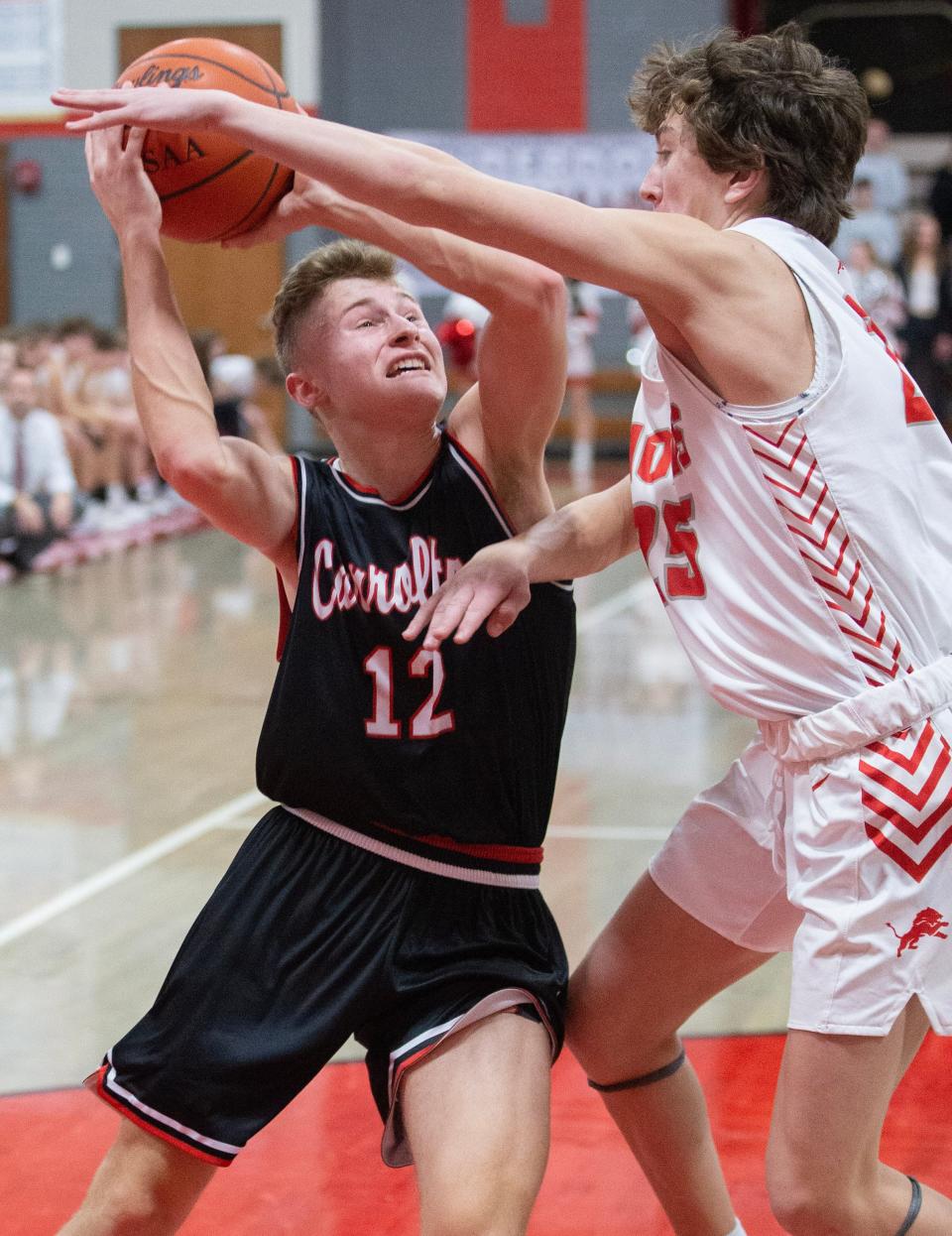 Carrollton's Jaxon Rinkes goes to the hoop with pressure from Minerva's Owen Shick in the second half at Minerva, Friday, Feb. 3, 2023.