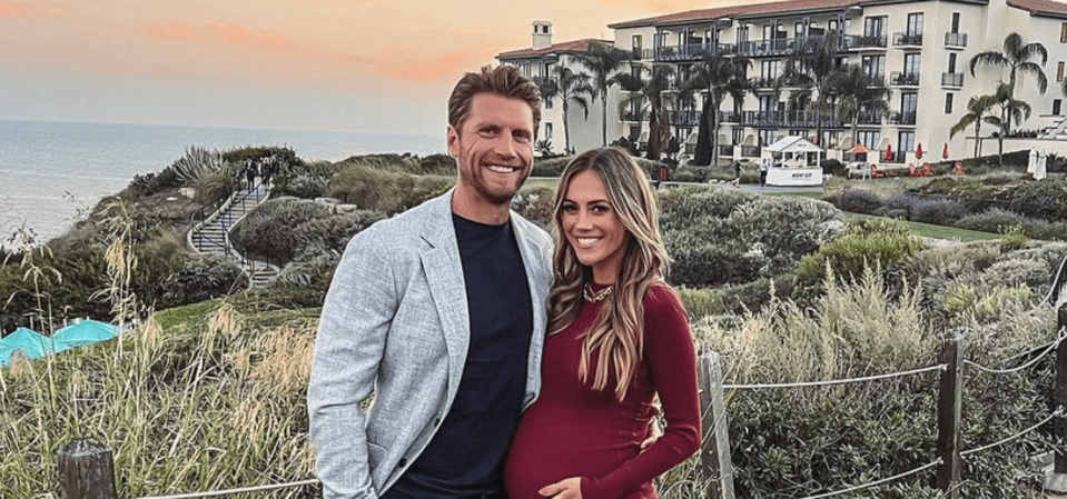 Jana Kramer and Allan Russell stand in front of a seaside resort (Jana Kramer / Instagram)