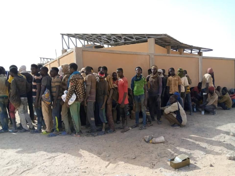 In this April 25, 2020 photo provided by IOM Niger, some of nearly 100 Nigeriens arrive in Assamaka, Niger, on foot from Algeria and now must be quarantined for two weeks at the remote Sahara border settlement, where water is scarce and midday temperatures reach over 110 degrees (45 degrees Celsius). Globally, coronavirus has marooned thousands of migrants in some of the world's harshest conditions on land and at sea. (IOM Niger via AP)