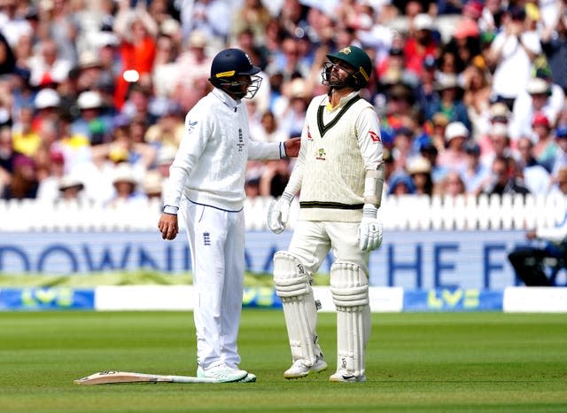 Nathan Lyon, right, with England fielder Joe Root