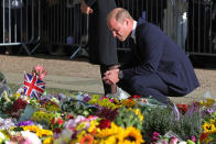 <p>Prince William, Prince of Wales looks at floral tributes laid by members of the public on his walkabout at Windsor Castle on Sept. 10, 2022 in England. (Photo by Chris Jackson - WPA Pool/Getty Images)</p> 