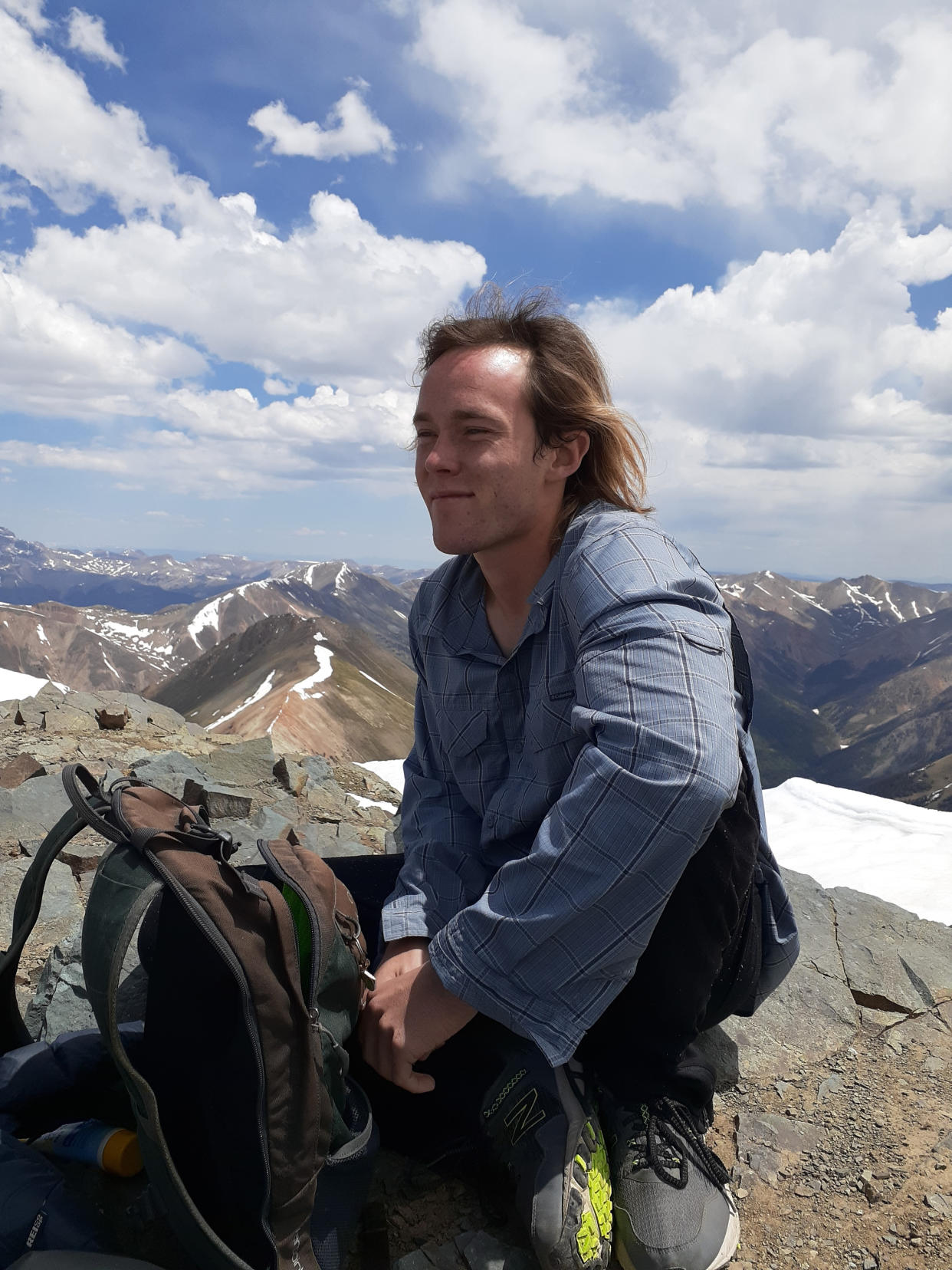 In this June 12, 2020 photo provided by Jean Granberg, her son Daniel Granberg sits at the top of Redcloud Peak, a mountain peak of over fourteen thousand feet, in the San Juan Mountains in Colorado. The body of the American man, who died while climbing one of Bolivia’s highest peaks, arrived Sunday, Sept. 5, 2021, in the country’s capital after a two-day recovery effort. Rescue workers said 24-year-old Granberg, of Colorado, died atop the Illimani mountain. (Jean Granberg via AP)