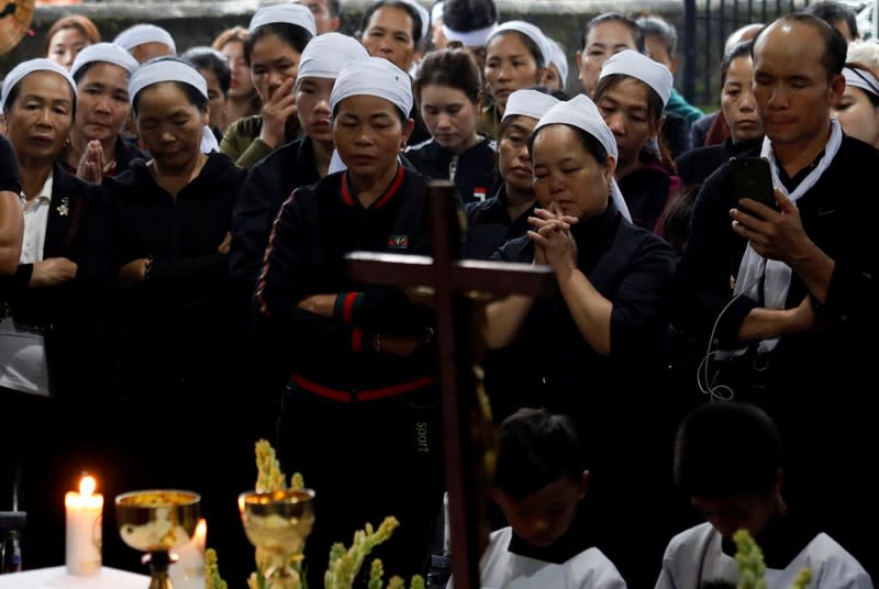 Relatives of John Hoang Van Tiep, one of the Vietnamese people found dead aboard a lorry in Britain, attend a funeral mass in Nghe An province