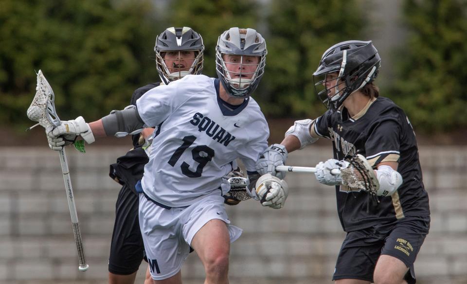 Manasquan James Farinacci gets double teamed as he bring the ball downfield. Manasquan Boys Lacrosse defeats Point Pleasant Boro in Manasquan, NJ on April 27, 2022. 