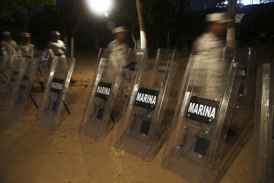 Shields used by Mexican National Guards stand on the Mexican side of the Suchiate River near Ciudad Hidalgo, Mexico, before sunrise Wednesday, Jan. 22, 2020, on the border with Guatemala. The number of migrants stuck at the Guatemala-Mexico border continued to dwindle Wednesday as detentions and resignation ate away at what remained of the latest caravan. (AP Photo/Marco Ugarte)