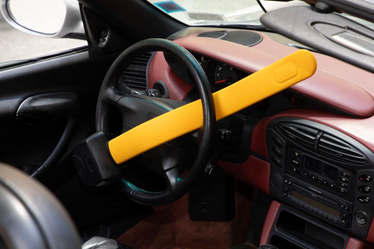 a stoplock steering wheel lock attached to a porsche wheel