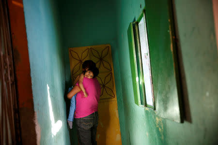 Isabel Buelvas, carries her grandson Kaleth Heredia, 2, a neurological patient being treated with anticonvulsants, at their house in Caracas, Venezuela January 30, 2017. REUTERS/Carlos Garcia Rawlins